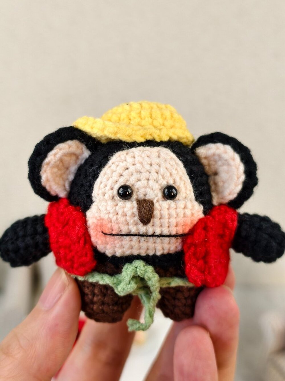 Handmade Amigurumi Crochet Monkey Wearing a Red Vest and a Yellow Hat Plushie